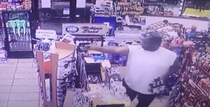 Watch video of alleged armed robber shot by customer holding beer in his free hand at a Cassopolis mini mart.