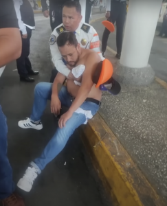 Wounded Mexico City police officer being cared for by colleague.