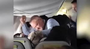 Alaska Airlines Flight Attendant Punching Passenger Who is Allegedly Assaulting Female Caught on Camera. Credit NBC News